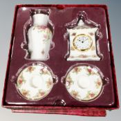 A Royal Albert Old Country Roses four piece candle stick and mantel clock and vase set in box.