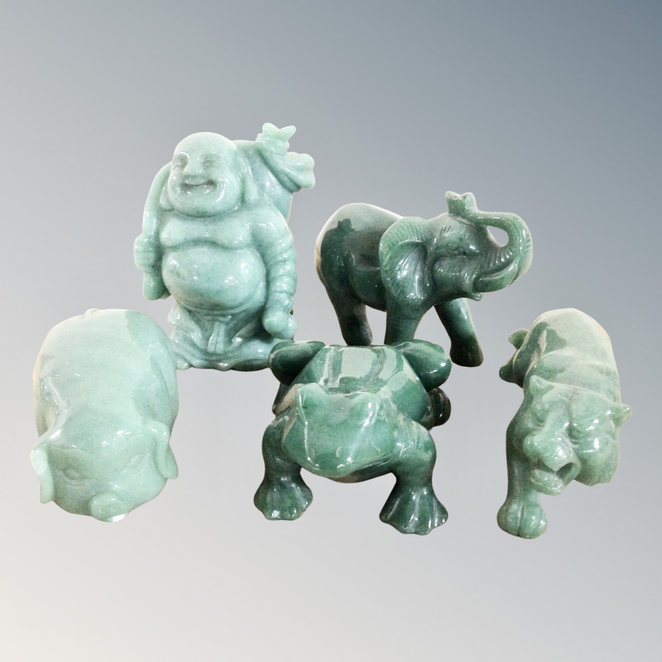 A green polished stone figure - Buddha together with four further polished stone animal figures