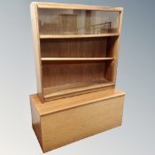 A set of mid 20th century sliding glass door bookshelves (missing doors) together with a teak