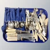 A tray of stainless steel and plated flatware