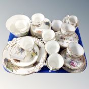 A tray of two vintage china tea services