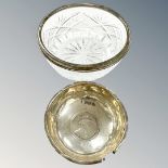 A silver coin-inset dish and a silver-rimmed bowl.