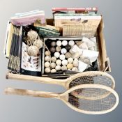 A box of vintage tennis racket, tennis balls and and early 20th century and later golf balls,