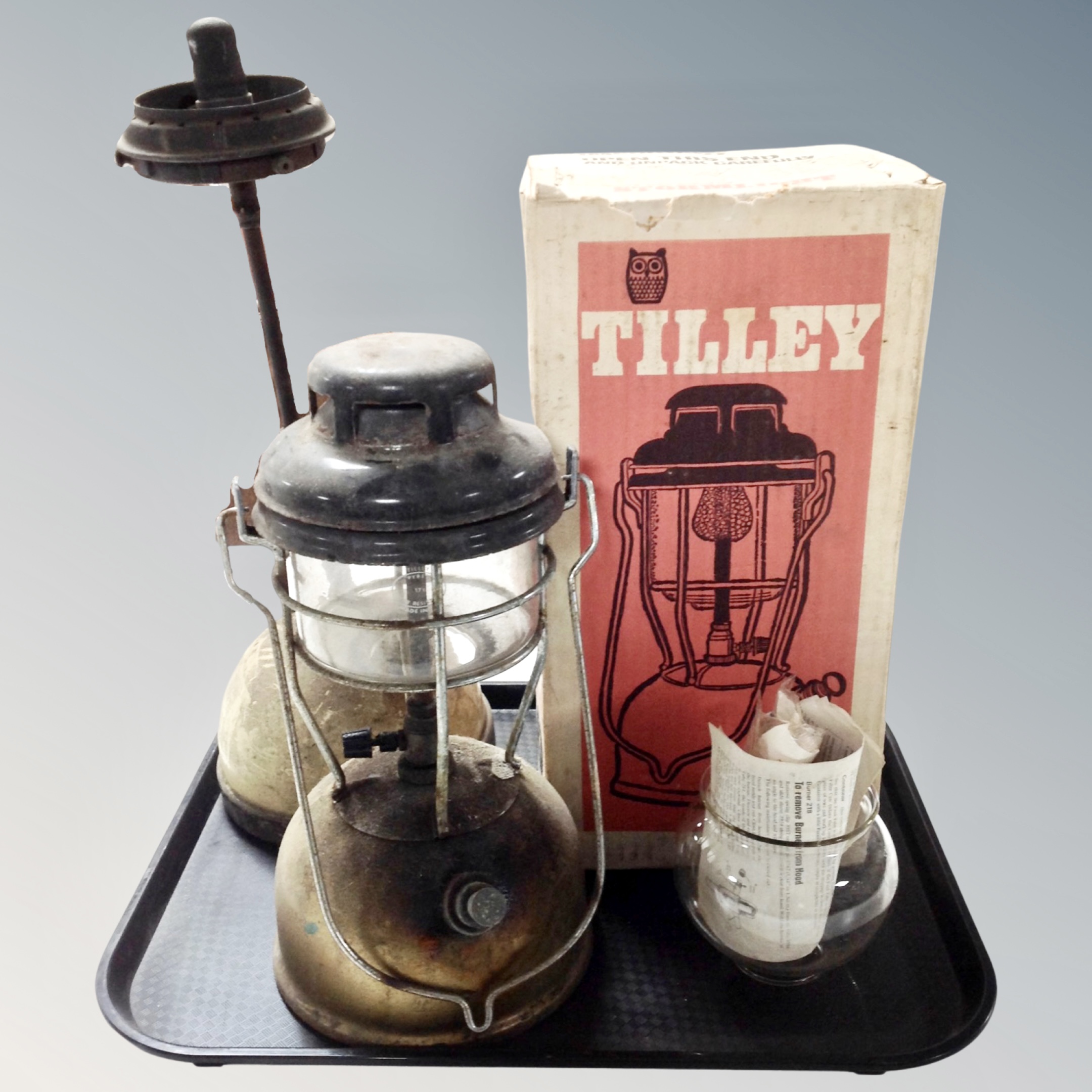A vintage Tilley storm light X246B in original box together with two further paraffin lamps