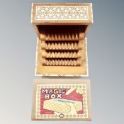 A 20th century wooden musical concertina cigarette box with mother of pearl inlay together with