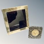A square silver photo frame, 8.25cm, together with a further embossed silver photo frame.