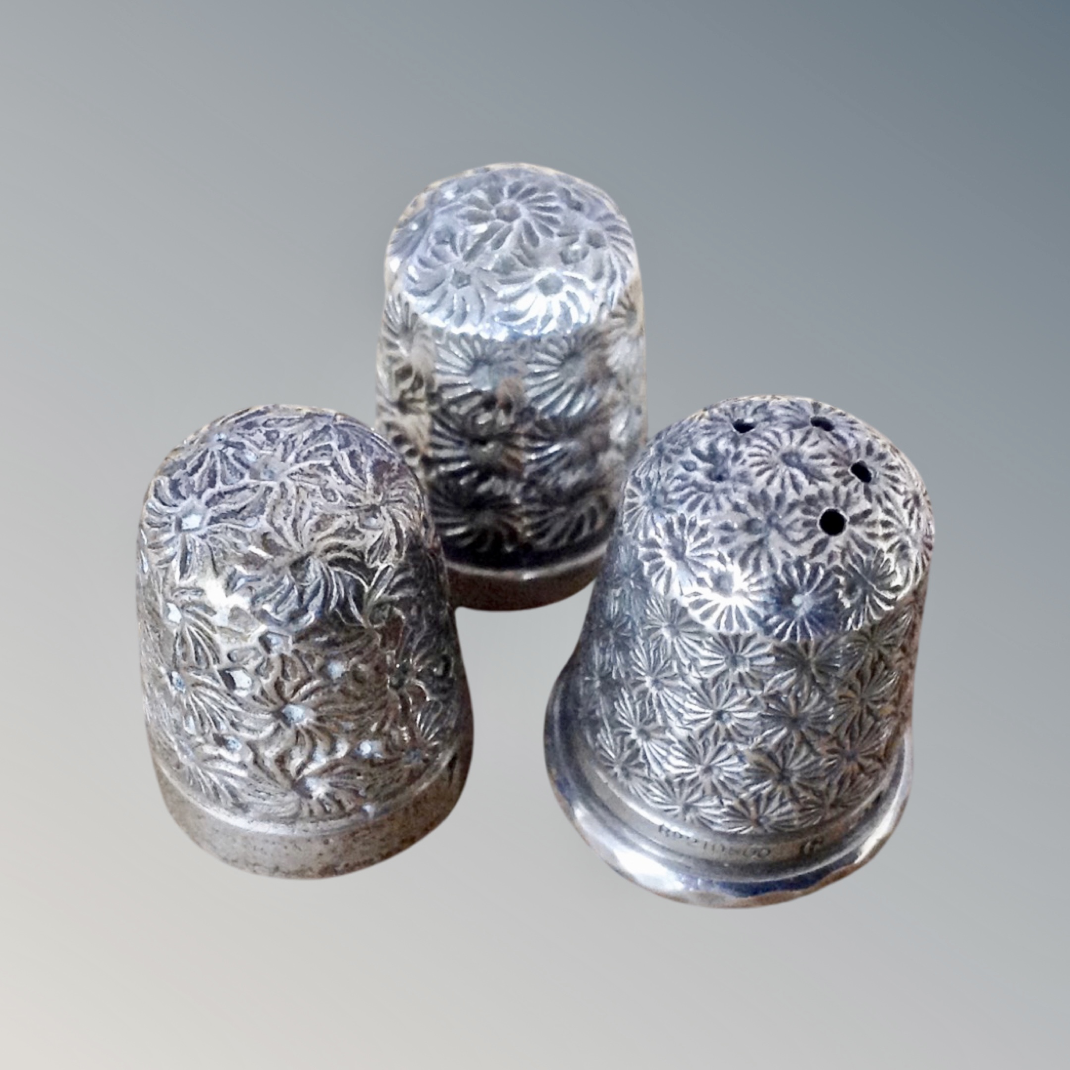 Three hall marked silver thimbles,