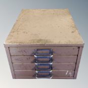 A metal table top four drawer index chest