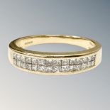 An 18ct gold princess-cut diamond half-eternity ring, size Q. CONDITION REPORT: 4.