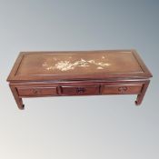 A Chinese hardwood low coffee table fitted three drawers with mother of pearl inlay,