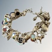 A silver and enamelled charm bracelet, variously stamped 'Sterling' or '800'.