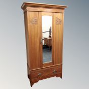 An Art Nouveau satin wood mirrored wardrobe fitted a drawer together with two drawer dressing chest