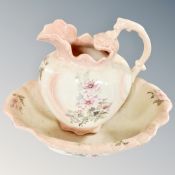 An English pottery pink rose patterned wash jug and basin.