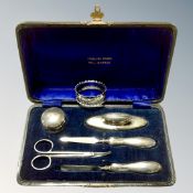 A four piece cased silver-handled manicure set together with a further pair of nail scissors in