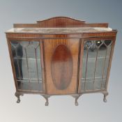 A 19th century mahogany framed double door display cabinet with central panel door on claw and ball
