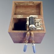 A vintage electric shock machine in fitted wooden box