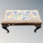 An antique tapestry footstool on Queen Anne style legs