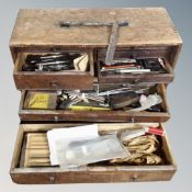 A vintage wooden eight drawer tool chest containing tools,