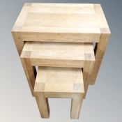 A nest of three contemporary oak tables