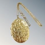 An engraved 9ct gold locket on similar chain. CONDITION REPORT: Gross weight 10.4g.