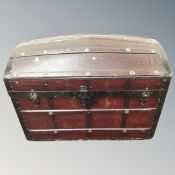 An early 20th century wood and metal bound domed topped trunk