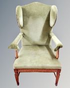 A 19th century oak framed armchair upholstered in green dralon.