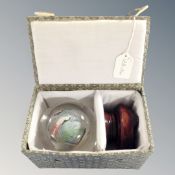 A Chinese reverse painted ball on stand in fitted box