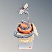 A Vax vacuum cleaner with hose in box