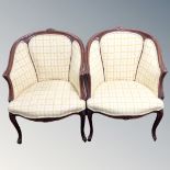 A pair of carved beech French style tub armchairs