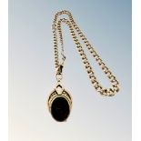 A 9ct gold Albert chain upon which hangs a bloodstone and carnelian-inset swivel locket
