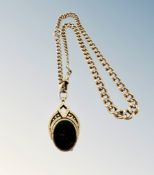 A 9ct gold Albert chain upon which hangs a bloodstone and carnelian-inset swivel locket