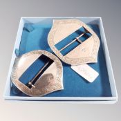 A pair of engraved silver buckles