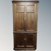 A George III oak double panel door corner cabinet