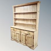 A 19th century pine farmhouse kitchen dresser fitted cupboards,