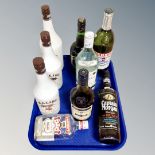 A tray of nine bottles of alcohol to include Malibu, Smirnoff, Martel Cognac,