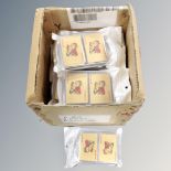 A box of twenty twin packs of 24ct foil overlay playing cards