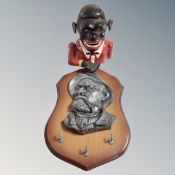 A cast iron novelty money box together with a three hook key rack with embossed plaque depicting a