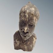 A carved bust of an African man