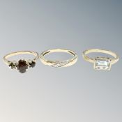 Three 9ct gold gem set rings. CONDITION REPORT: Garnet ring with one stone missing.