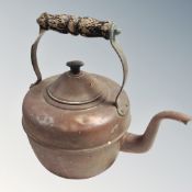 A vintage copper wooden handled kettle