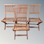 A set of four teak folding garden chairs