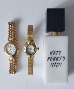 A Katy Perry's Indi 30 ml eau de parfum and 2 gold tone watches fitted with new batteries