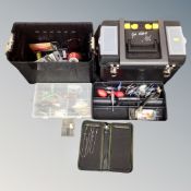 A plastic portable tool box trolley containing fishing equipment, hooks, lures,