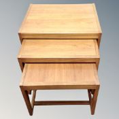 A nest of three teak tables