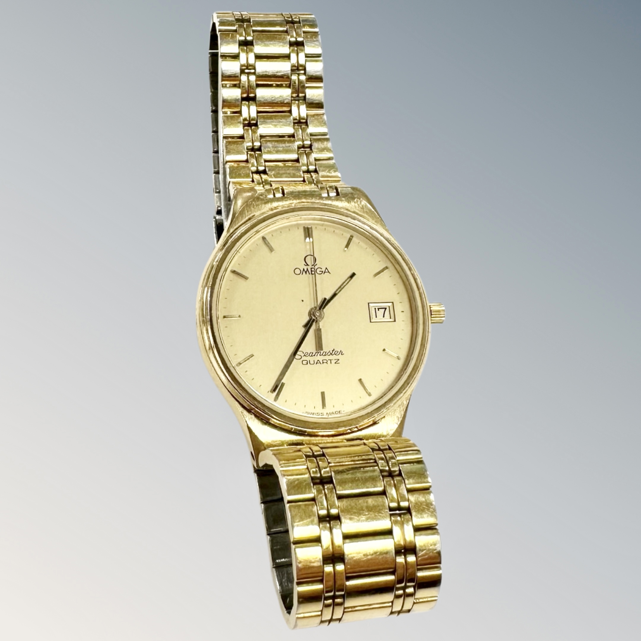 A gent's gold plated Omega Seamaster quartz calendar wristwatch, on Omega bracelet, case 31mm.