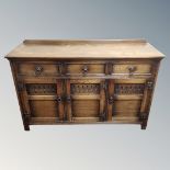 A 20th century triple door sideboard with three drawers CONDITION REPORT: