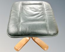 A Scandinavian style footstool in green leather