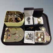 A tray of assorted costume jewellery, Harrods pen set, enamel badges, watches,
