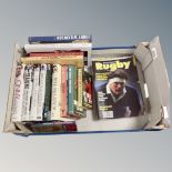 A box of books relating to rugby and rugby magazines
