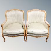 A pair of carved beech French style salon chairs